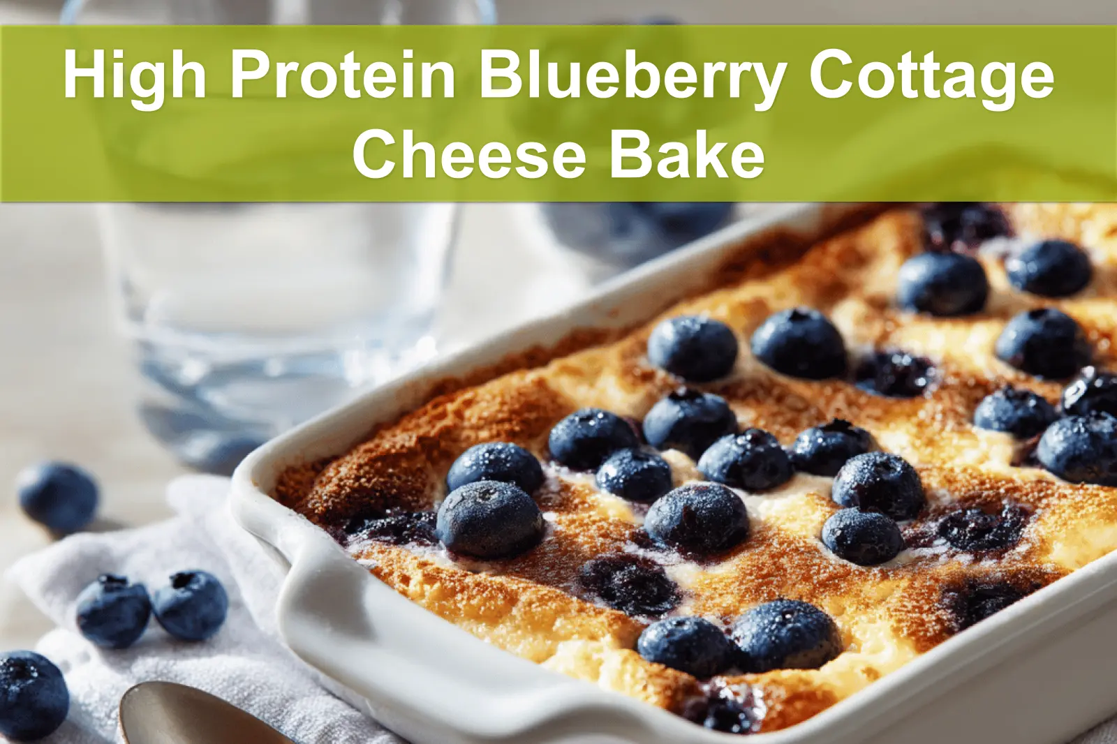 High Protein Blueberry Cottage Cheese Bake plated on white cloth with fresh blueberries and graham crumbs