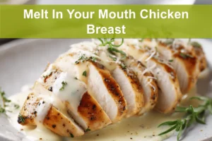 Melt In Your Mouth Chicken Breast plated with creamy white sauce and grated hard cheese warm lighting