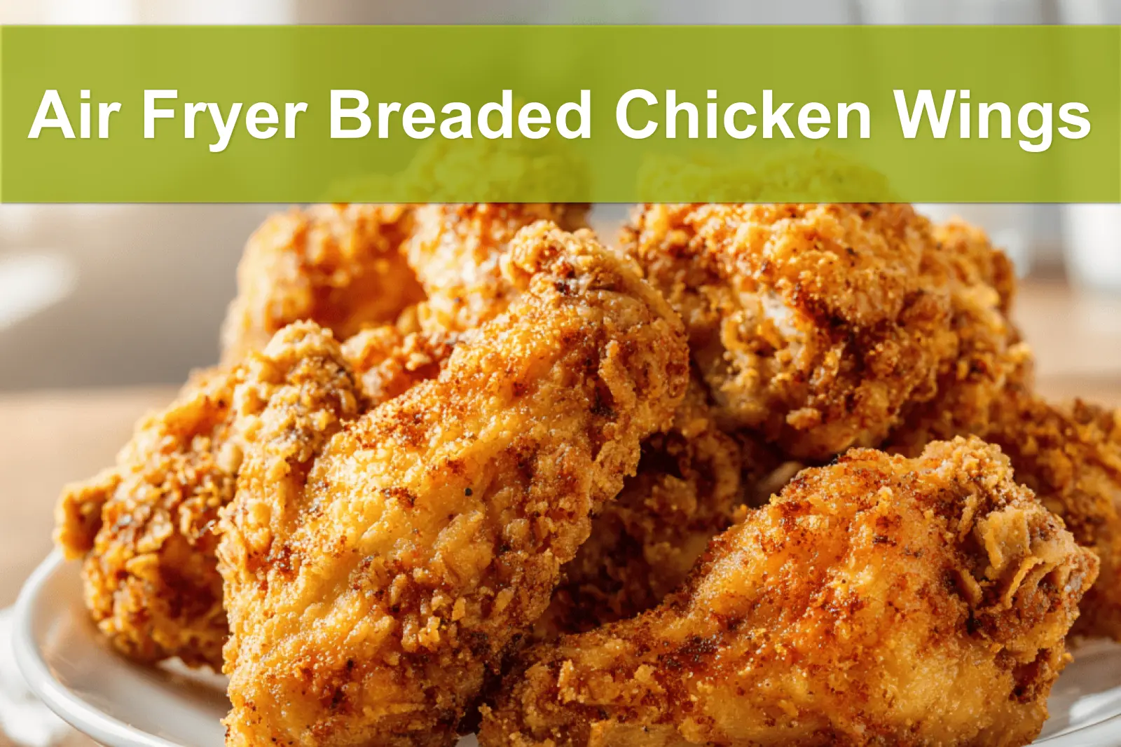 Air Fryer Breaded Chicken Wings plated with golden crust and simple glass of water