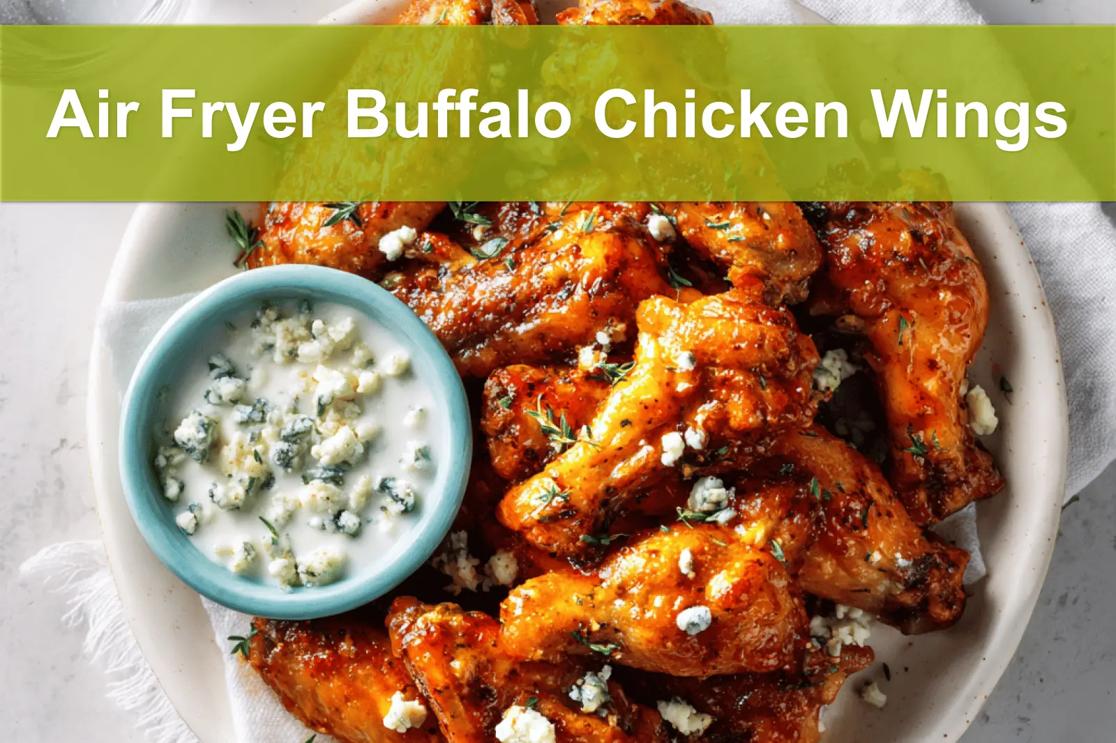 Air Fryer Buffalo Chicken Wings on white napkin with blue cheese dressing and water