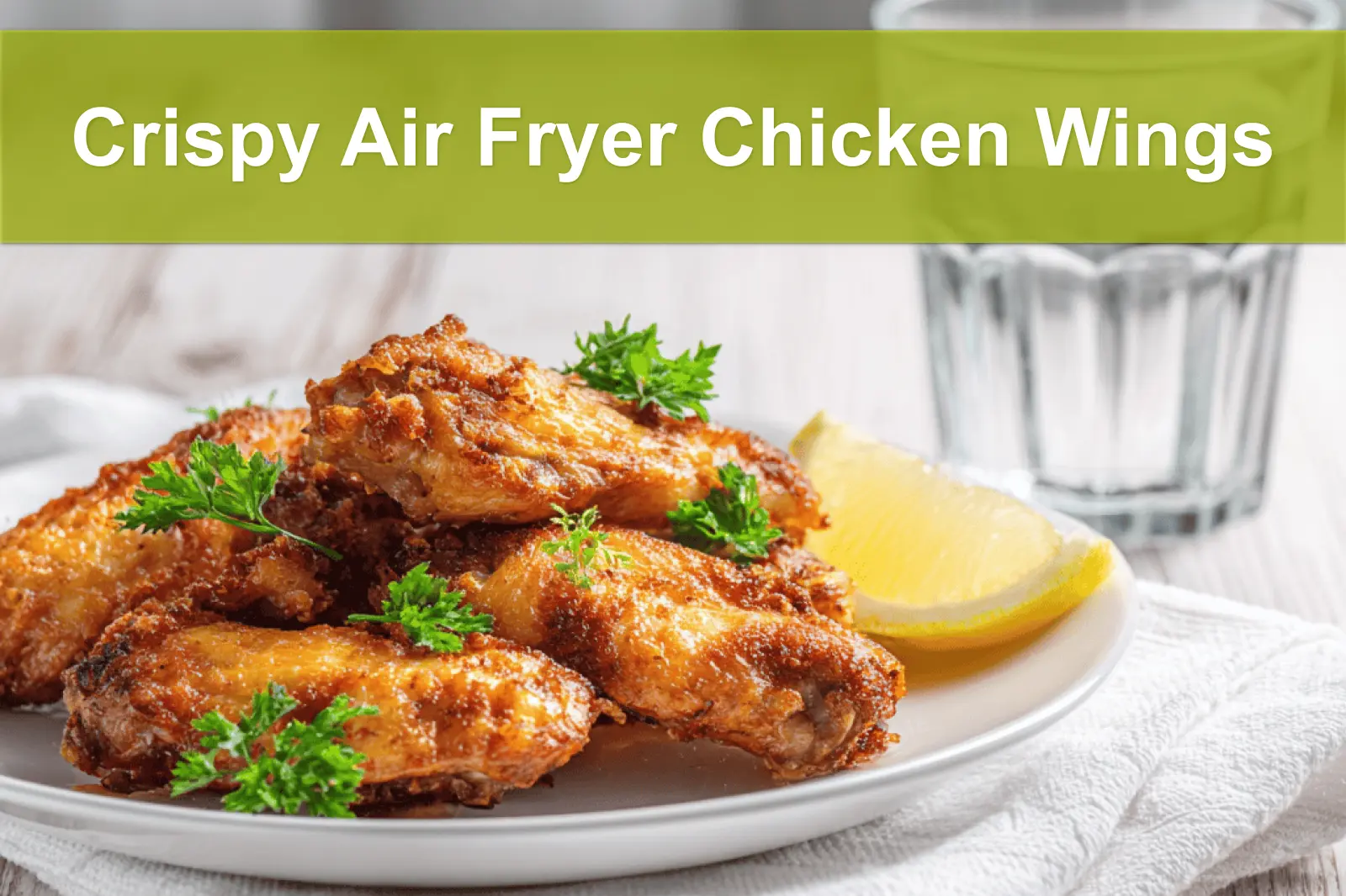 Crispy Air Fryer Chicken Wings served on white napkin with clear glass of water warm lighting