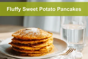 Fluffy Sweet Potato Pancakes stacked with melted butter and syrup on white napkin beside clear water glass