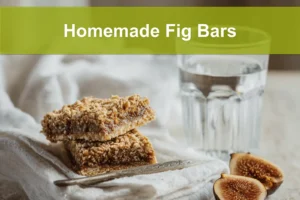 Homemade Fig Bars golden oat crust with fig jam filling styled on white cloth beside water