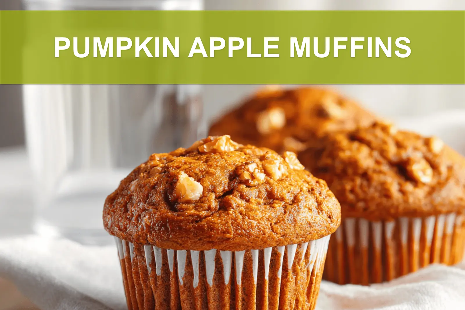 PUMPKIN APPLE MUFFINS hero shot three quarter angle warm tones on white cloth