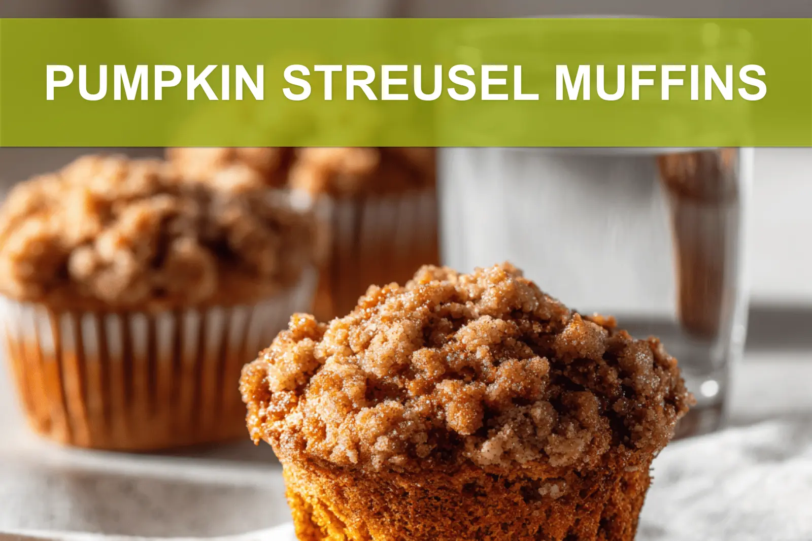 PUMPKIN STREUSEL MUFFINS on white cloth with clear glass of water warm light