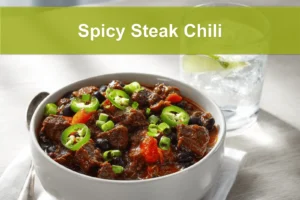 Spicy Steak Chili in bowl on white napkin warm inviting natural light glass of water