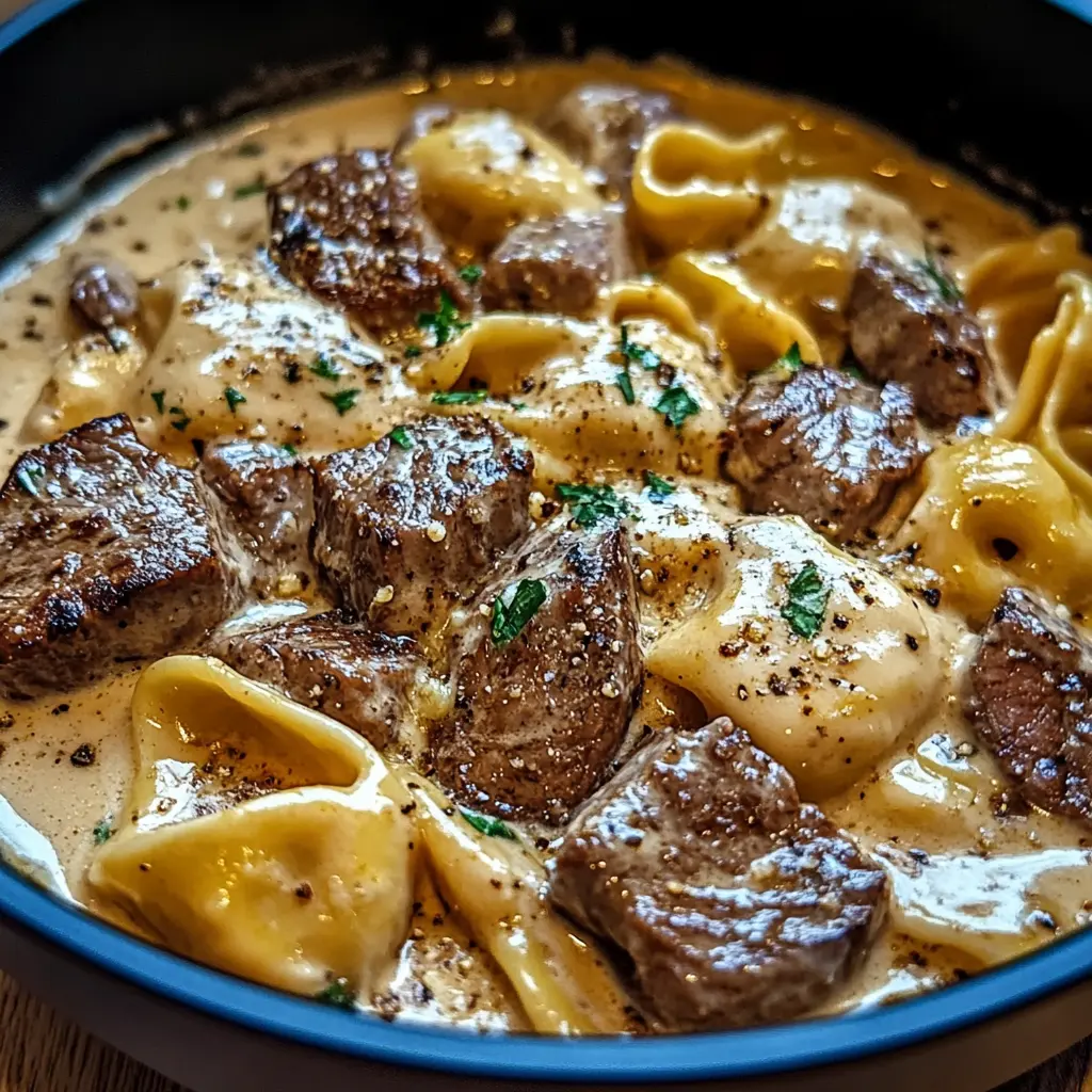 Cracked garlic steak tortellini in creamhouse sauce, centered hero view with a clean and uncluttered presentation