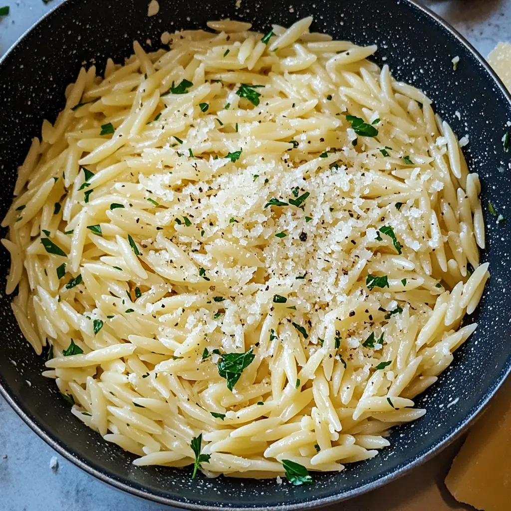 Creamy Garlic Parmesan Orzo Pasta in a serving bowl, centered hero view