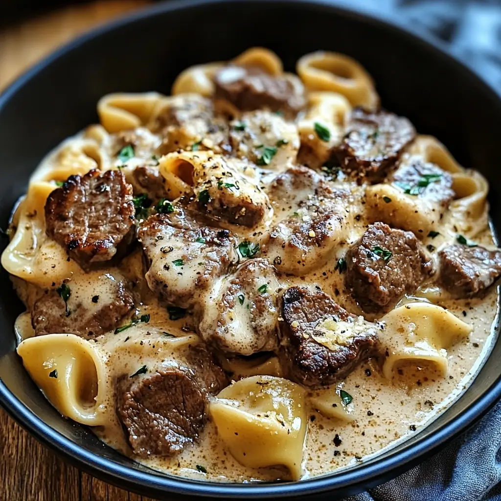 CRACKED GARLIC STEAK TORTELLINI IN CREAMHOUSE SAUCE BLISS centered hero view, clean and uncluttered