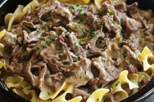 Crock Pot Beef and Noodles Easy Comforting Weeknight Dinner CROCK POT BEEF AND NOODLES centered hero view, clean and uncluttered